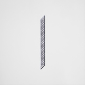 Narrow navy and white geometric print silk twilly scarf, shown flat with dark border edges