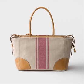Prada Accessories neutral canvas tote bag with pink stripe detail, tan leather handles, trim, and corner patches, gold-tone hardware