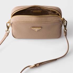 Prada Accessories powder pebbled leather crossbody bag, open to show interior, gold-tone zip and triangle logo hardware, with adjustable strap