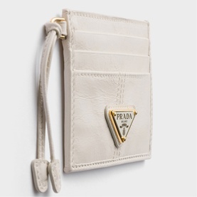 Prada Accessories white leather card holder with gold triangle logo plaque and lanyard strap, multiple card slots visible