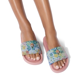 Model wearing Kurt Geiger London blue floral mosaic embellished slides with pink footbed and open toe