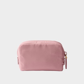 Pink nylon cosmetic pouch with gold-tone zip puller and tab detail, dome-shaped silhouette