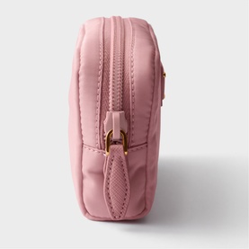 Pink quilted cosmetic pouch with gold-tone zip pulls and structured side profile, small rectangular format