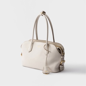 Cream leather structured tote bag with twin top handles, gold-tone hardware, and detachable shoulder strap