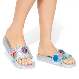 Model wearing Kurt Geiger London multi metallic silver slide sandals with holographic gem embellishments and pearl-trim strap detail
