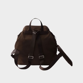 Prada Accessories brown nylon backpack, rear view, with dark brown leather straps, silver-tone buckles and top carry handle.