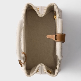 Prada Accessories neutral bag interior, showing beige canvas lining, tan leather tab closure and gold-tone hardware details.