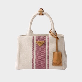Prada canvas tote bag in cream with pink stripes, gold triangle logo, tan leather handles and detachable luggage tag