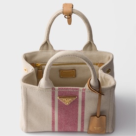 Prada canvas tote bag in cream with pink stripe detail, gold-tone hardware, tan leather top handles and hanging tag