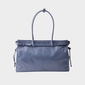 Slate blue leather tote bag with dual top handles, silver-tone hardware, and side drawstring ties on white background.