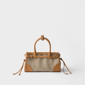 Prada Accessories neutral canvas and tan leather small handbag with structured top handles, gold-tone hardware, and drawstring details.