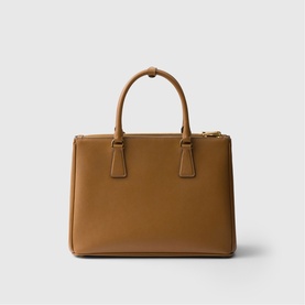 Prada Accessories brown structured tote bag with dual top handles, gold-tone hardware, and zip fastening, front view