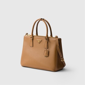 Prada Accessories brown saffiano leather tote bag with dual top handles, gold-tone hardware, and removable crossbody strap
