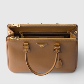 Prada Accessories brown leather tote bag, open top view showing interior compartments, gold-tone hardware and dual handles