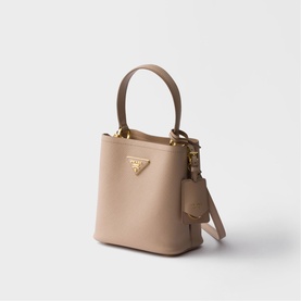Prada Accessories powder saffiano leather bucket bag with gold triangle logo, top handle, detachable strap and mini pouch charm