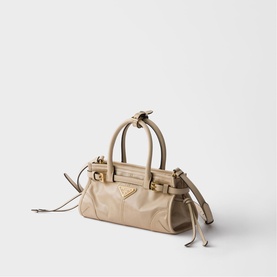 Prada Accessories neutral leather mini tote bag with gold-tone hardware, double top handles, triangle logo and drawstring side details