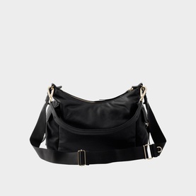 Black slouchy crossbody bag with gold-tone hardware, adjustable flat shoulder strap, and zip closure, shown on white background.