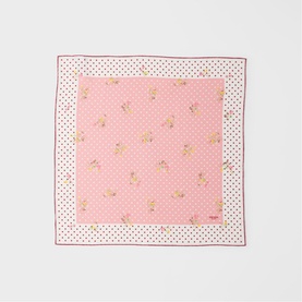 Pink silk scarf with scattered floral print, polka dot border and burgundy edge detail, laid flat