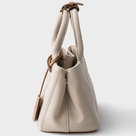 Prada Accessories neutral leather tote bag with quilted detailing, short top handles, tassel zip pull, and gold-tone hardware
