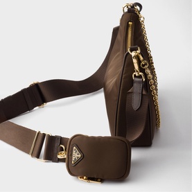 Prada dark brown nylon shoulder bag with gold-tone chain strap, wide fabric strap, and attached mini triangle logo pouch