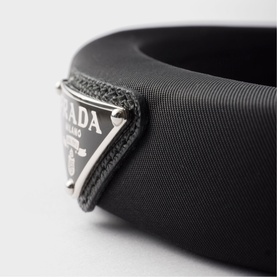 Prada Accessories black fabric bangle with silver-tone triangular logo plaque detail.