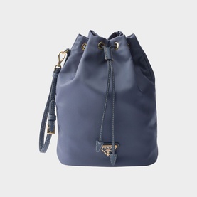 Prada Accessories blue nylon bucket bag with gold-tone hardware, drawstring closure, triangle logo charm, and wrist strap