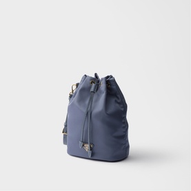 Prada Accessories blue nylon bucket bag with gold-tone hardware, drawstring closure, and detachable shoulder strap.