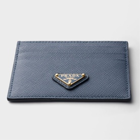 Prada Saffiano leather card holder in slate blue with gold-tone triangular logo plaque, multiple card slots visible.