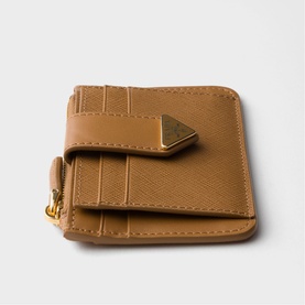 Tan saffiano leather compact wallet with gold-tone hardware clasp and zip detail, multiple card slots visible