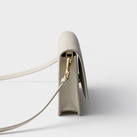 Prada Accessories neutral leather structured crossbody bag, gold-tone clasp hardware, slim shoulder strap, side profile view