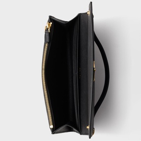 Black structured bag interior view, showing gold-tone zip, open top compartment, and flat base detail
