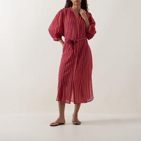 Model wearing Sea Level Vacay Boho Striped Shirt Dress in Spice Red, midi length with balloon sleeves and tie belt, styled with flat sandals.