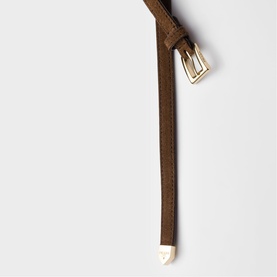 Tan suede slim belt with gold-tone buckle and white metal tip detail, laid flat on white background.