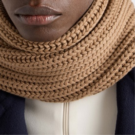 Model with camel chunky knit snood scarf, styled with a dark navy top