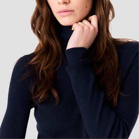Model wearing Maje navy ribbed knit roll-neck jumper, close-up detail shot
