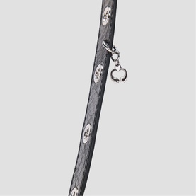Maje red bag strap with monogram print and silver clover charm detail