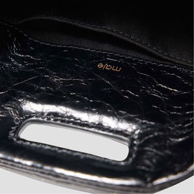 Maje black crinkled patent leather bag interior, showing fabric lining and gold logo stamp detail