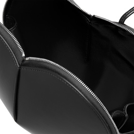 Alaia Le Coeur Crossbody Bag in Noir, interior view showing black leather lining and silver-tone two-way zip fastening