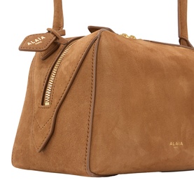 Alaia Terre D'Ombre suede leather shoulder bag with gold-tone zip and logo lettering, close-up detail shot
