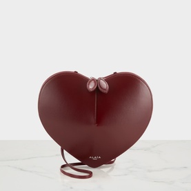 Alaia Le Coeur Crossbody Bag in Rouge Grenat, heart-shaped calf leather with silver-tone hardware and adjustable crossbody strap