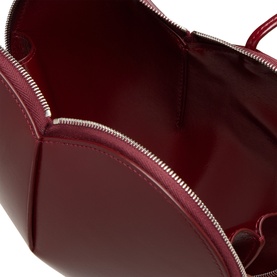 Alaia Le Coeur Crossbody Bag in Rouge Grenat calf leather, interior view showing two-way zip fastening and silver-tone hardware