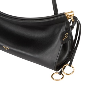 Alaia Le Click Medium Shoulder Bag in noir smooth leather with gold-tone hardware, decorative ties, metal ring detailing and adjustable strap.