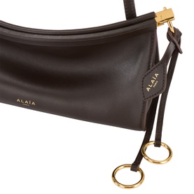 Alaia Le Click Small Shoulder Bag in Marron Fonce smooth leather, gold-tone hardware, decorative ties with metal rings and logo lettering detail