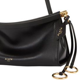 Ala&iuml;a Le Click Small Shoulder Bag in noir smooth leather, gold-tone hardware, decorative ties with metal ring detail and logo lettering.