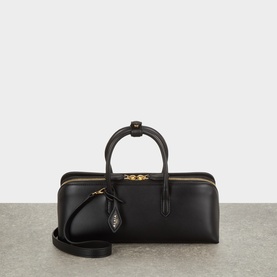 Alaia Noir calf leather tote bag with gold-tone hardware, structured silhouette, top handle, and detachable crossbody strap