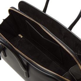 Alaia Noir calf leather tote interior view showing gold-tone zip pockets and suede-effect black lining
