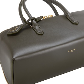 Alaia Vert Camouflage calf leather tote bag with gold-tone hardware, dual top handles and zip closure, close-up detail view