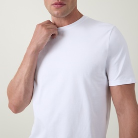 Model wearing Arne Essential Solid T-Shirt in white, crew neck, short sleeves, soft-touch jersey with slight stretch