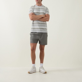 Model wearing Arne Marl Grey Crew Neck T-Shirt with grey shorts and white trainers, arms crossed.