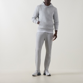 Model wearing Arne Essential Solid Hoodie in Marl Grey with matching joggers and grey trainers.